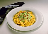 Ravioli with herb and bacon sauce