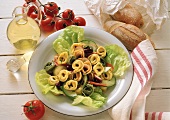 Tortellini salad with cucumber, red beans and radishes