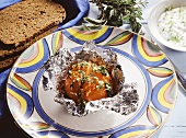 Grilled tomato with herb & garlic sauce in aluminium foil
