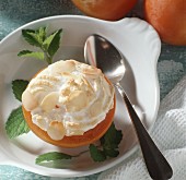 A halved sharon fruit with almond meringue topping