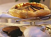 Warm venison quiche with truffles on cake stand
