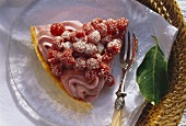 A piece of raspberry cheesecake on cake plate