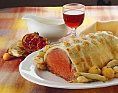 Roast beef in puff pastry with fried vegetables