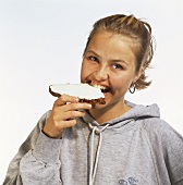 Woman Eating Toast with Cream Cheese