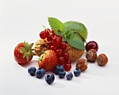 Still life with berries, nuts, cherry and lime