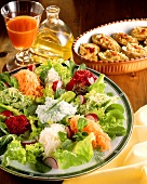 Salad plate with raw vegetables, carrot juice, stuffed potatoes