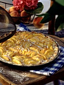 Peach tart in round baking dish