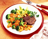 Slice of beef with mixed broccoli and carrots and potatoes