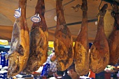 Pieces of Pork Hanging in a Meat Market