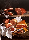 Several Assorted Hams on Wood