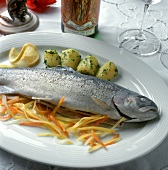 Trout cooked blue with vegetables & potatoes on platter