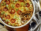 Salted herring & spinach bake with tomatoes & spring onions