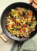Stir-fried vegetables with beef and sprouts in wok