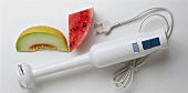 A Hand Blender with Slices of Melon