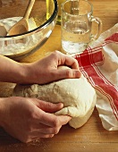 Kneading Pizza Dough on a Wooden Counter