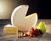 A Wheel of Brie Cheese with a Wedge Taken Out