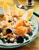 Cheese and chicory salad with oranges, grapes, walnuts