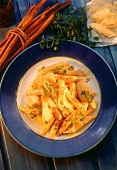 Cinnamon penne with chervil and parmesan on blue plate