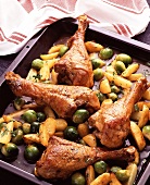 Turkey legs on Brussels sprouts & potatoes on baking sheet