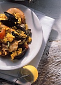 Paella with rabbit, shrimps, clams and mussels