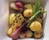 Boiled potatoes with bacon and spring onions