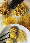Various pastas on spoons, plate and loose