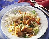 Fried red perch pieces on leeks and bean sprouts with rice