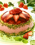 Two layer domed strawberry gateau with chopped pistachios