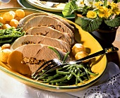 Stuffed leg of lamb in slices with potatoes & green beans