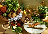 Still life with vegetable basket, mushrooms, herbs, oil & grain