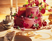 Two-tier raspberry gateau decorated with marzipan hearts
