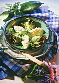 Cucumber mousse dumplings with vegetable salad in deep plate