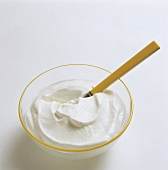 Creamy cream quark in bowl with spoon