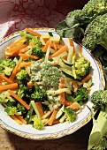 Mixed vegetables with herb cream sauce on plate