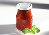 Tomato sugo in screwtop jar, decoration: basil leaf