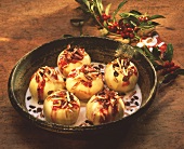 Baked apples with jam and raisin filling in a dish