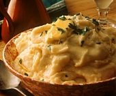 Mashed potato with butter & chopped parsley in dish