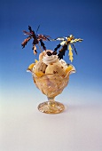 Sundae: 4 scoops of ice cream, peaches & two cocktail sticks