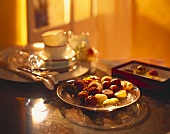Assorted chocolates on glass plate on table