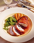 Stuffed chicken breast wrapped in bacon with vegetables 