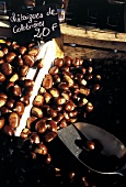 A Man Selling Chestnuts at an Outdoor Market