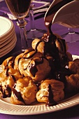 Profiteroles with white chocolate filling & chocolate sauce