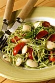 Green tagliatelle with white beans and tomatoes