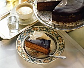 A piece of Sacher torte with fresh whipped cream