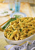 Pasta bake with Cheddar garnished with fresh chives