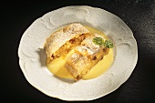 Two pieces of apple strudel with custard on plate