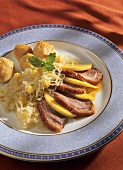 Sliced goose breast with mango sauerkraut