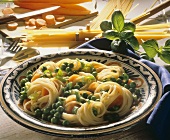 Spaghetti with peas, carrots & spring onions on plate