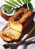 Loaf-shaped coconut cake, pieces cut on cake plate