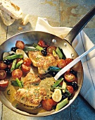 Stuffed turkey escalope with vegetables in pan